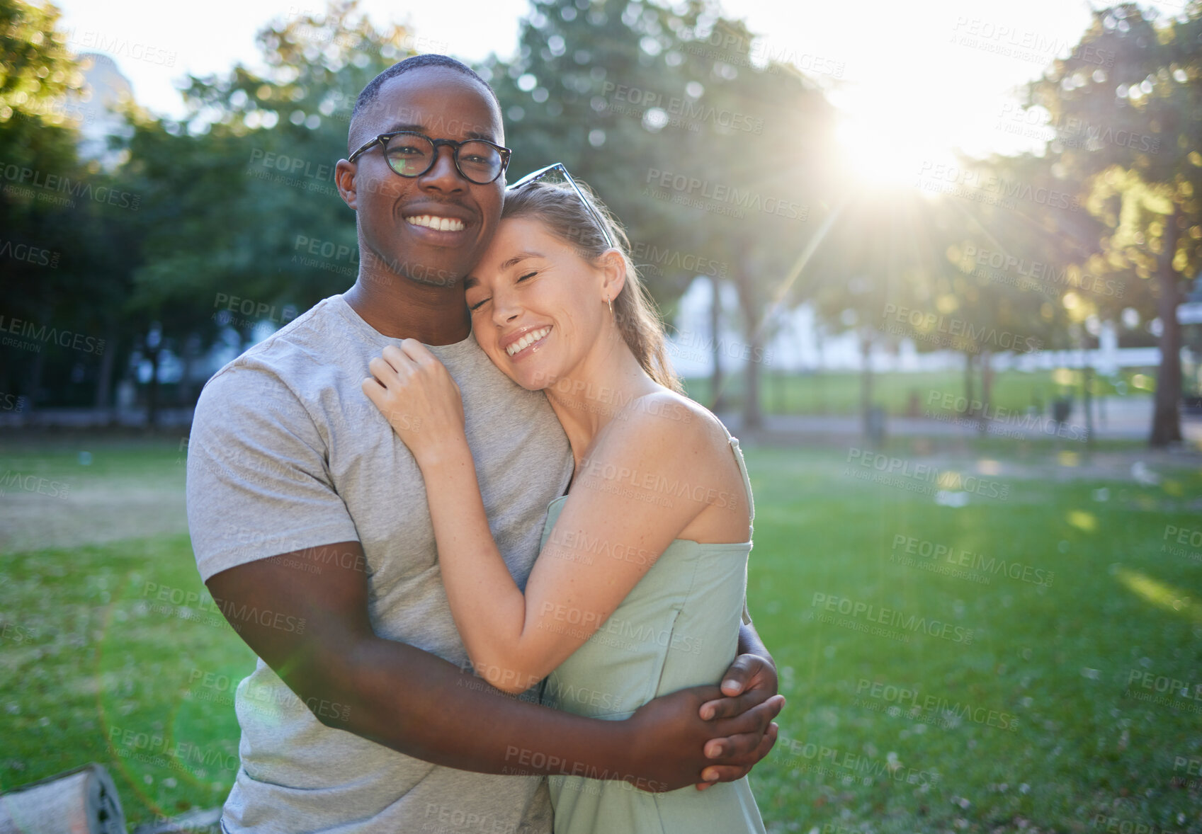 Buy stock photo Love, hug or couple of friends in a park on a relaxing romantic date in nature in an interracial relationship. Bonding, black man and happy woman enjoying quality time on a holiday vacation together