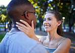 Love, interracial or couple of friends in a park bonding on a romantic date in nature in a marriage commitment. Embrace, relaxed black man and happy woman enjoying quality time on a holiday vacation 