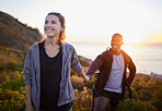 Hiking, fitness and interracial couple exercise in sunset on a mountain as a morning workout in nature. Happy people, man and woman in a relationship training for health and wellness together