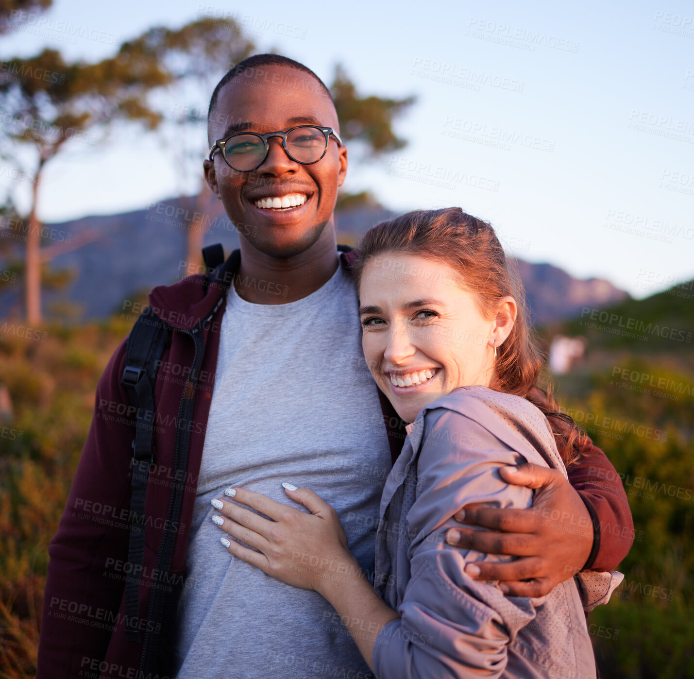 Buy stock photo Nature, happy and portrait of interracial couple on mountain for holiday, vacation and adventure on weekend. Travel lifestyle, dating and man hugging woman enjoy outdoor freedom, relax and peace