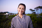 Happy, sunset and portrait of a woman in a park during dusk for peace, calm and zen. Adventure, hike and smile of a girl on a walk for fitness, summer cardio and relaxing during dawn in nature