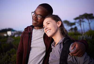 Buy stock photo Happy couple, relax and love in an interracial relationship during sunset in the evening or night outdoors in nature. Adventure, travel and people hugging outdoors on after hiking a mountain