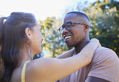 Buy stock photo Interracial couple, smile and hug for love, care or embracing relationship together in a nature park. Happy black man hugging woman and smiling in happiness for romance, embrace or support outside