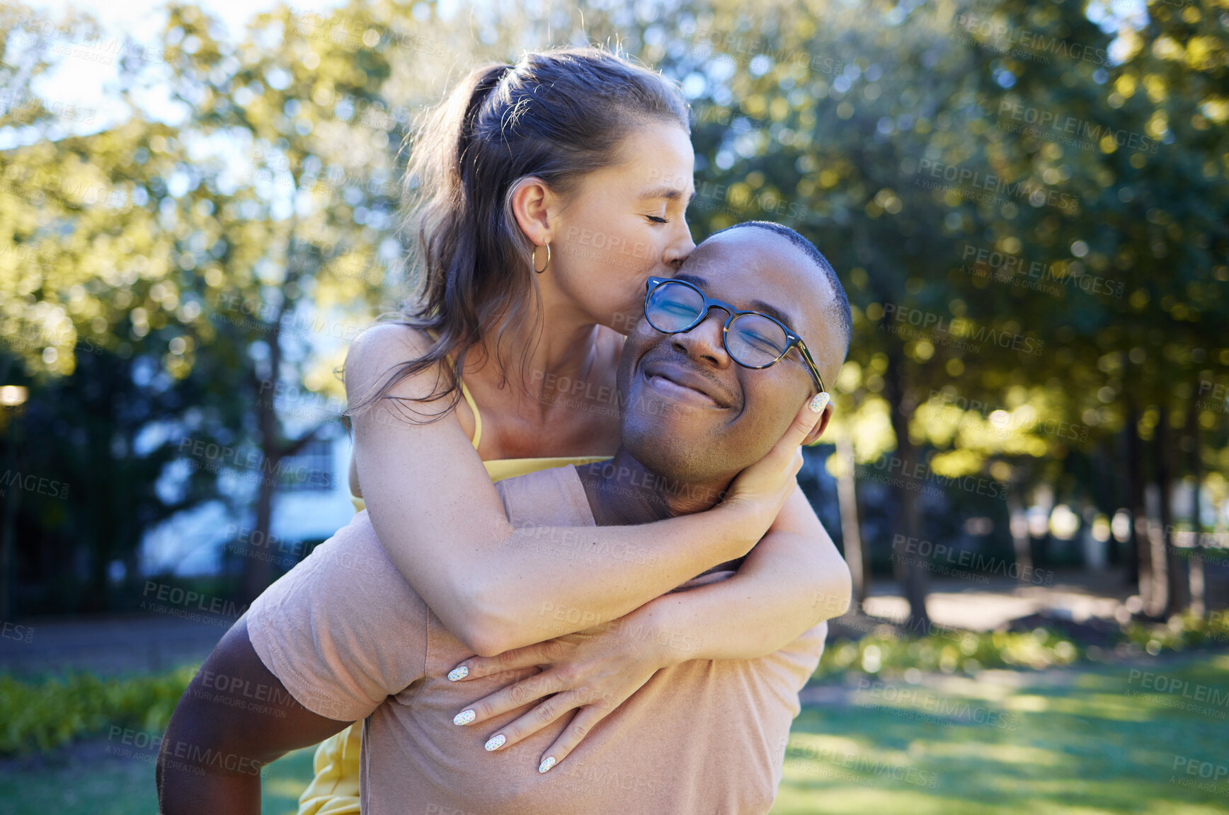 Buy stock photo Interracial, piggy back and couple in park, happiness and bonding for romance, loving and smile. Romantic, black man and woman on back, nature and love for relationship, dating and playful together