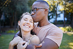 Interracial, couple hug and date in park, happiness outdoor and nature, love and commitment in relationship. Trust, support and happy woman with smile, black man is content with peace and fresh air