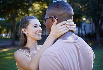 Buy stock photo Love, park and smile with an interracial couple bonding outdoor together on a romantic date in nature. Summer, romance and diversity with a man and woman dating outside in a green garden