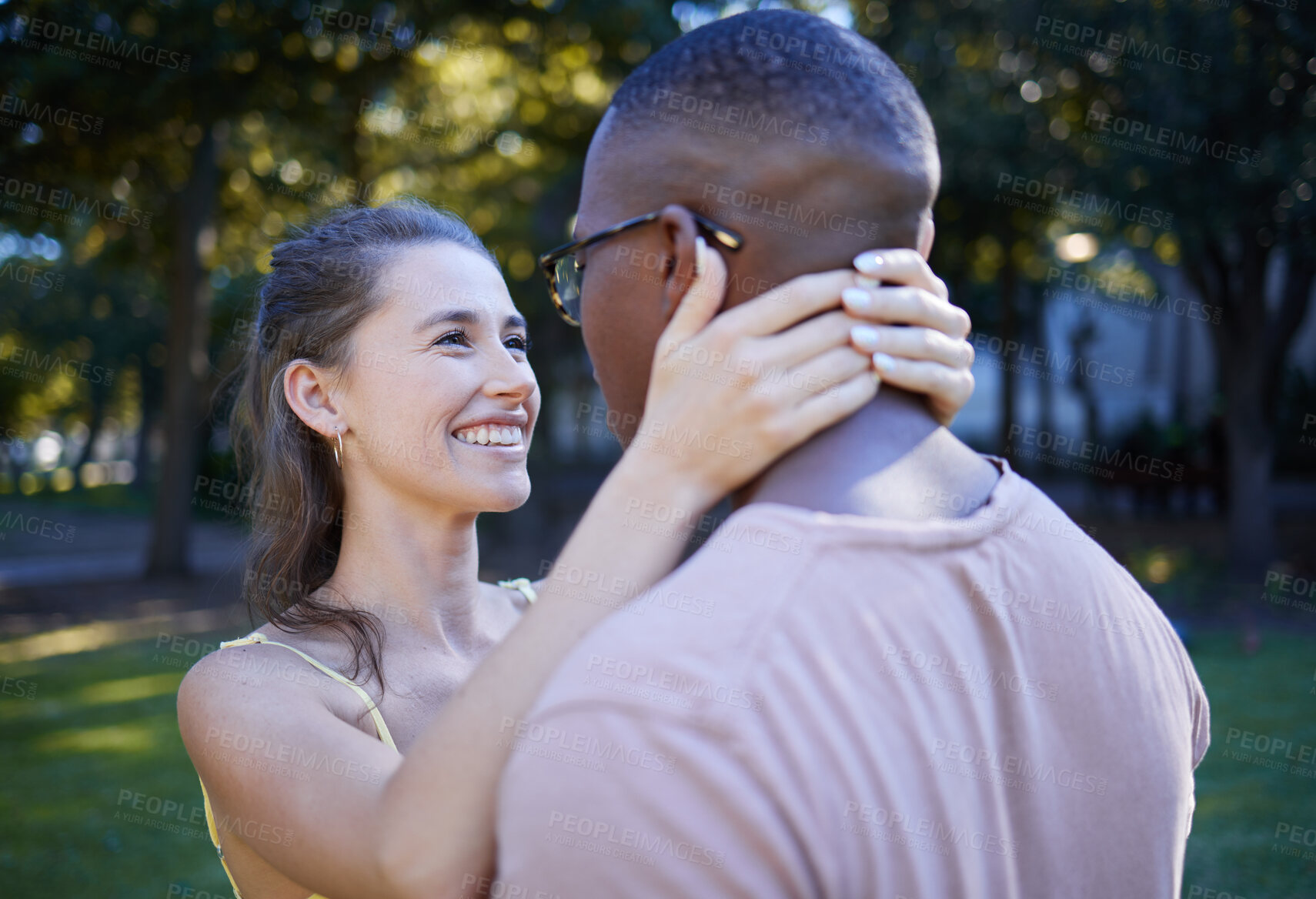 Buy stock photo Love, park and smile with an interracial couple bonding outdoor together on a romantic date in nature. Summer, romance and diversity with a man and woman dating outside in a green garden