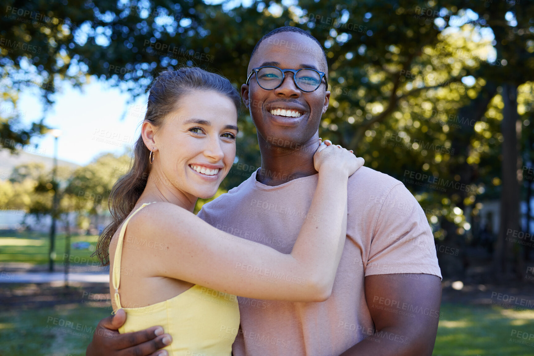 Buy stock photo Interracial, portrait and couple hug, park or smile for relationship, romance or bonding. Love, black man or woman romantic in nature, loving or happiness with embrace, dating or quality time outdoor