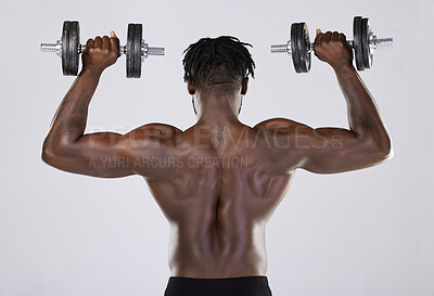 Buy stock photo Fitness, exercise and training of strong black man with dumbbell in studio. Body or back of bodybuilder person doing workout to train with weights for power, health and wellness or growth motivation