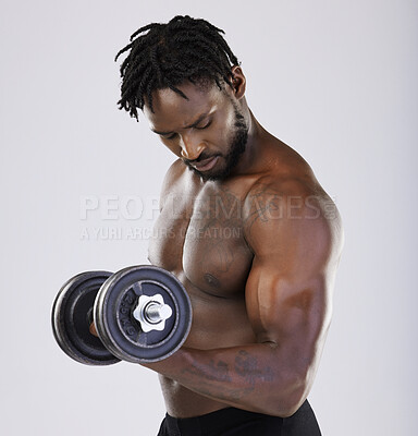 Buy stock photo Dumbbell, exercise and fitness of a strong black man doing muscle workout in studio. Body of sexy bodybuilder person training with weight for power, health and wellness or growth as sports motivation