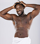 Nude, black man in towel and skin in portrait, shower and hygiene, grooming and beauty isolated on studio background. Smile, muscle and abs, strong and skincare glow, body care with natural cosmetics