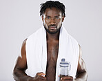 FItness, portrait and black man with towel and water for sports in studio for strong body muscle. Health and wellness of a sexy male bodybuilder model after exercise, workout and training for power