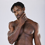 Black man, muscle and standing isolated on a grey background thinking, grooming or profile. Portrait of fit or attractive African American male, person or guy model in thought posing in the studio