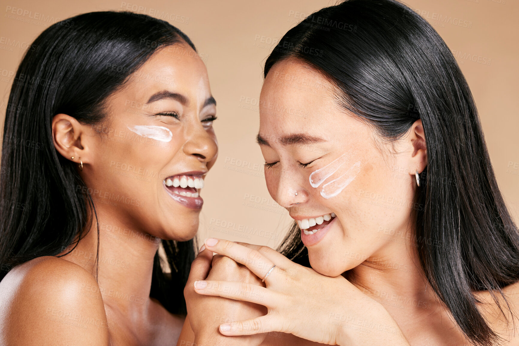 Buy stock photo Happy, beauty and skincare women with cream for face isolated on a beige studio background. Wellness, smile and Asian model friends with sunscreen for love of cosmetics and dermatology on a backdrop