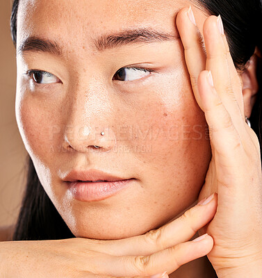 Buy stock photo Closeup face, hand frame and asian woman in studio with skincare, skin glow or healthy cosmetics. Happy japanese model, cosmetic beauty and aesthetic with self care health, wellness or natural makeup