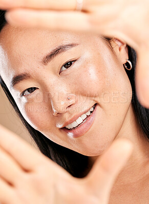 Buy stock photo Studio portrait, hand frame and asian woman with smile for skincare, natural skin glow and wellness. Happy Japanese model, cosmetic beauty and healthy aesthetic with self care dermatology headshot