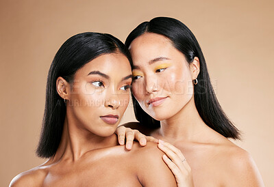 Buy stock photo Love of friends or women for skincare, makeup and cosmetics with diversity and inclusion in studio. Asian and black person for skin glow, spa facial and color on face with dermatology product