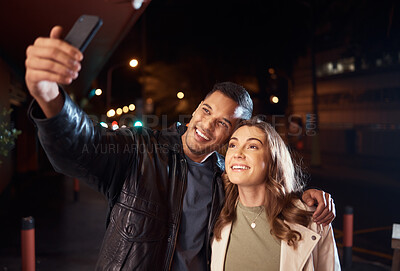 Buy stock photo Couple of friends, phone or night selfie on city street or road for social media, profile picture or birthday celebration vlog. Smile, happy or influencer people bonding in dark while live streaming