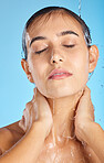 Woman, shower water and face of a calm model ready for morning skincare and wellness. Blue background, studio and isolated female relax with peace from facial beauty cleaning and self care alone