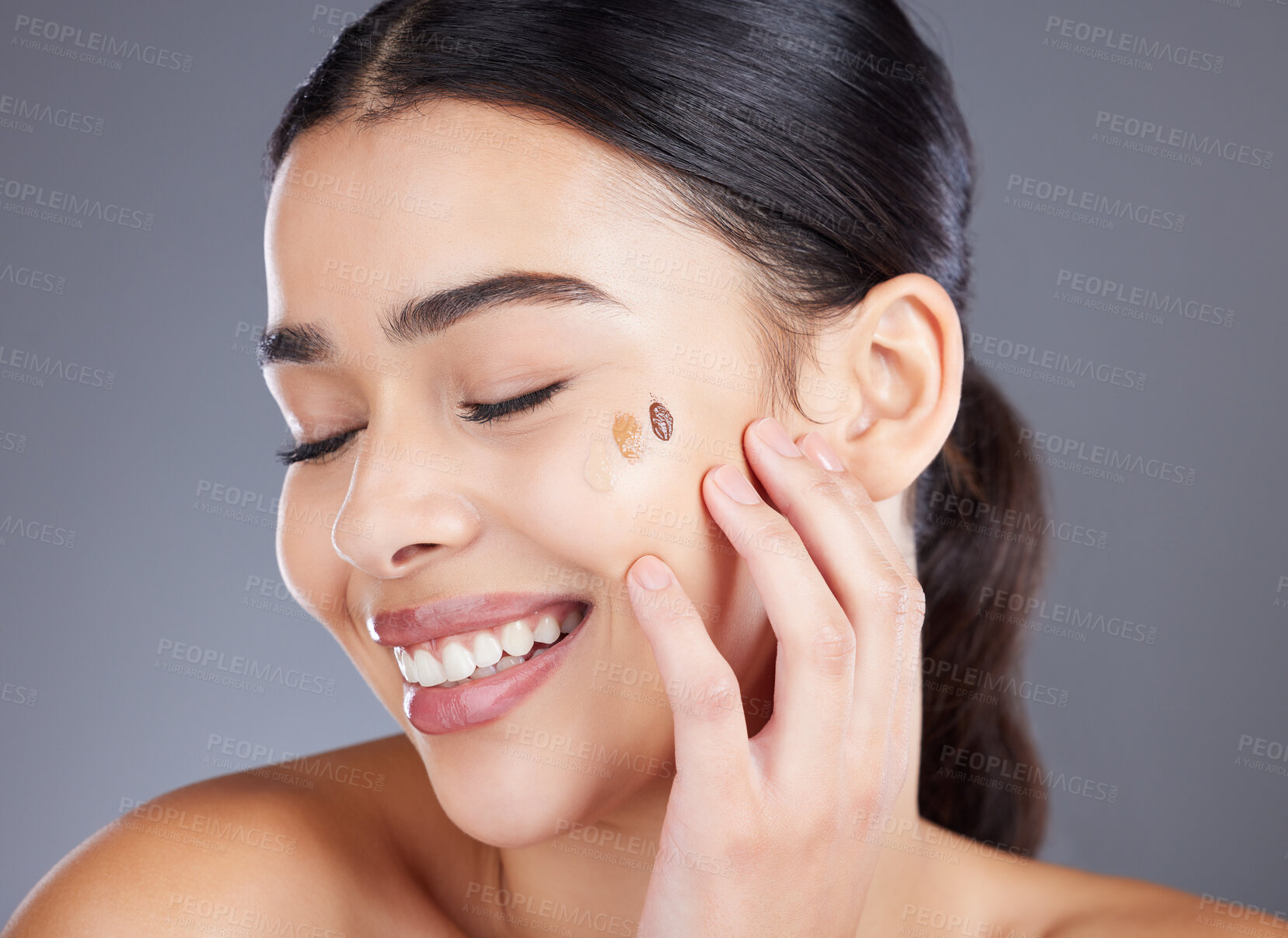 Buy stock photo Beauty, foundation test and face of woman with skincare product for self care, anti aging or wellness. Facial healthcare, spa salon and happy aesthetic girl with makeup cosmetics on studio background