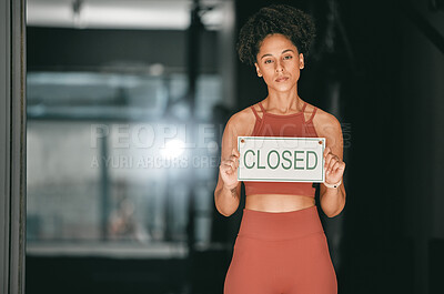 Buy stock photo Fitness, portrait or personal trainer at gym with a closed sign for workout exercises or training. Manager, bankruptcy or serious black woman holding a board to stop exercising in empty health club