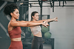 Training, stretching and friends with women in gym for training, workout and exercise. Teamwork, health and personal trainer with girl and muscle warm up for wellness, sports and progress goals