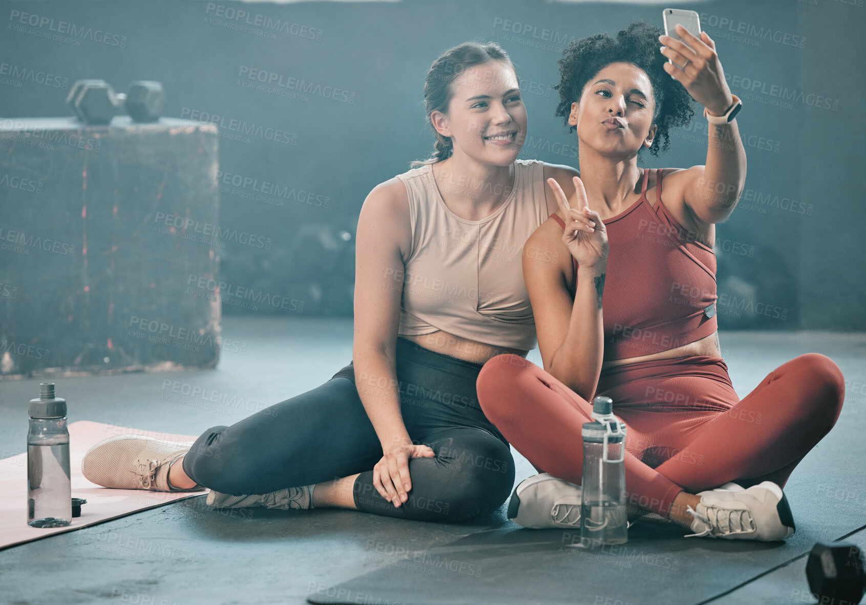 Buy stock photo Woman, friends and fitness with phone for selfie, peace sign and pout after workout, exercise or training at gym. Sporty women with smile looking at smartphone for photo or healthy wellness together