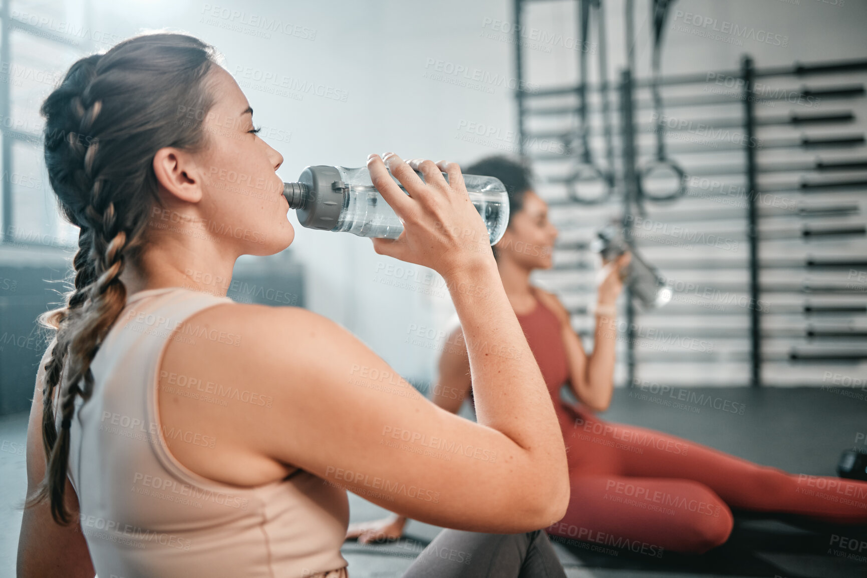 Buy stock photo Fitness, gym and relax friends drinking water for sports thirst hydration, performance workout or exercise running. Athlete health, fatigue and tired women with liquid bottle drink after training