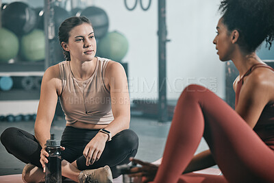 Buy stock photo Relax, friends or women at gym talking about fitness training goals, workout progress or exercise on a break. Resting, sports girl and healthy black woman in conversation, discussion or speaking