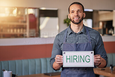 Buy stock photo Recruitment, portrait or man with a hiring sign for job vacancy offer in cafe or small business store. Hospitality, labour shortage or happy entrepreneur smile with an onboarding message to hire