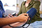 Blood pressure, hospital and hypertension health test of doctor hand consulting a woman. Nurse, consultant and health care worker for life insurance checking cardiovascular results with monitor