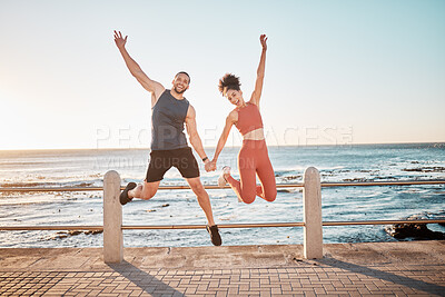 Buy stock photo Fitness, jump and portrait of a couple at beach for training fun, support and celebration of goal. Energy, happy and excited man and woman jumping while holding hands at the sea for cardio in Spain