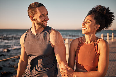 Buy stock photo Black couple, fitness and walking at the beach with smile for conversation, talk or sunset together in the outdoors. Happy man and woman enjoying fun walk smiling for holiday break by the ocean coast
