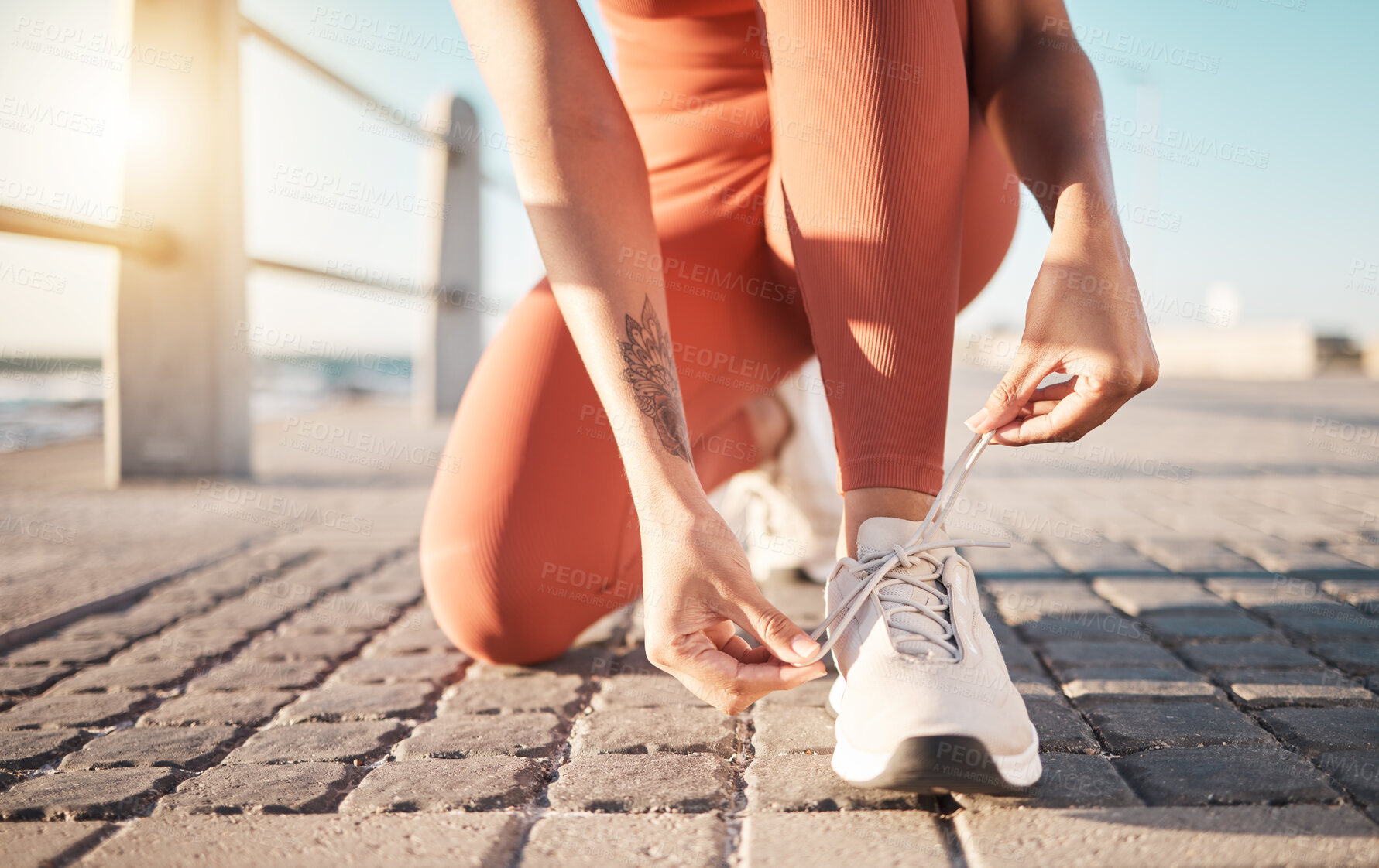 Buy stock photo Shoelace, fitness and woman ready for running, sports and training on the ground in Puerto Rico. Motivation, performance and feet of a runner tying laces to start a marathon and cardio workout