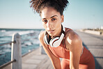 Portrait, fitness and tired with a black woman runner on the promenade for cardio or endurance exercise. Running, workout or health with an attractibe young female athlete training outdoor by the sea