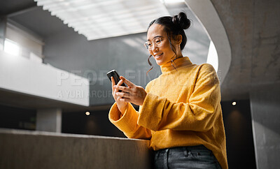 Buy stock photo Phone, texting and woman in office building, happy and smile while on internet, search and reading. Asian, girl and business entrepreneur on smartphone for research, social media or browsing in Japan