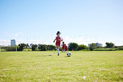 Buy stock photo Soccer, training or children and a girl team playing with a ball together on a field for practice. Fitness, football and grass with kids running or dribblinf on a pitch for competition or exercise