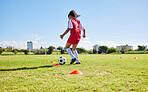 Football girl child, field and training for fitness, sports and development of balance for control, speed and strong body. Female kid, fast soccer ball dribbling or workout feet on grass for learning