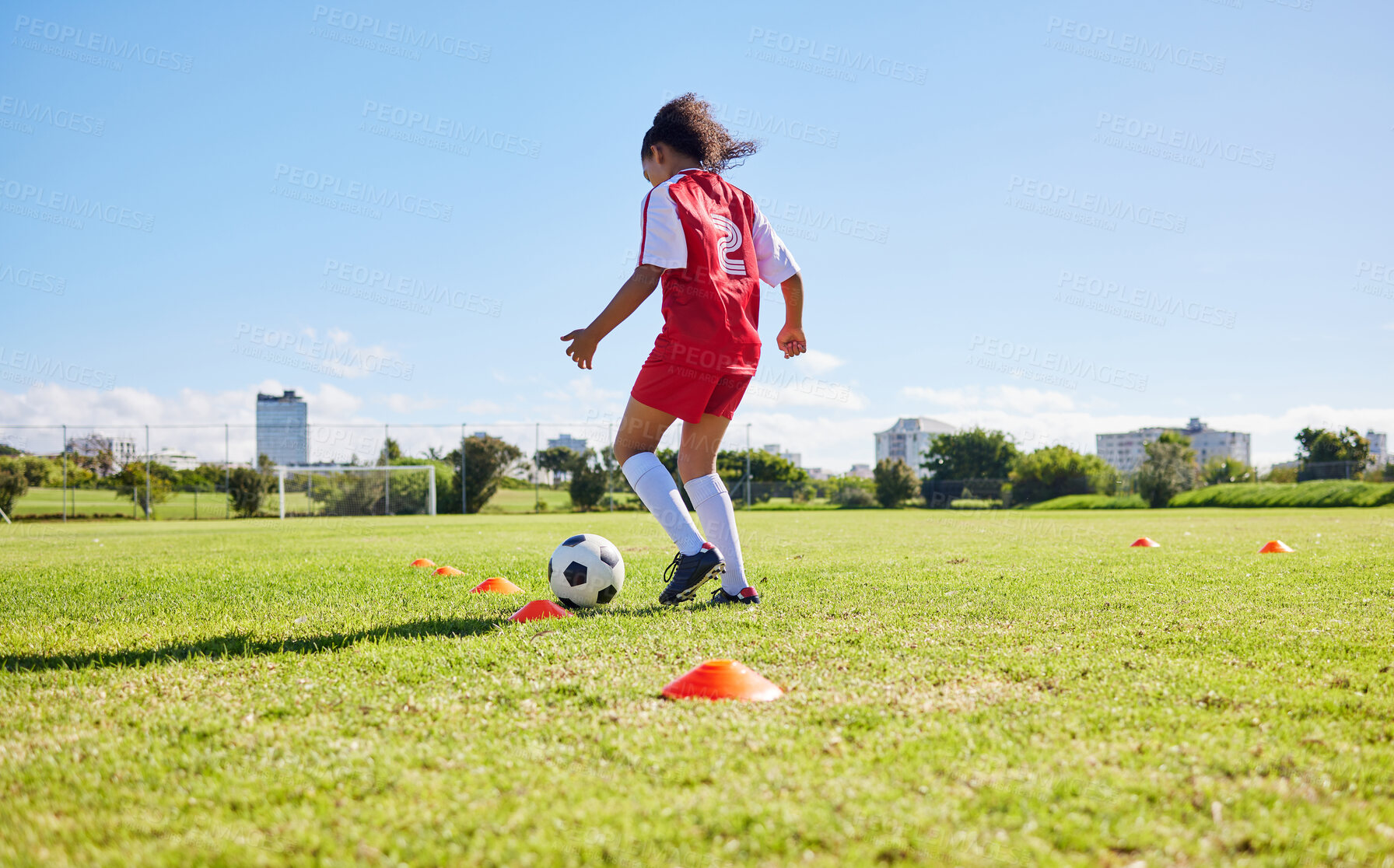Buy stock photo Football girl child, field and training for fitness, sports and development of balance for control, speed and strong body. Female kid, fast soccer ball dribbling or workout feet on grass for learning