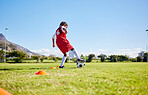 Soccer girl child, field and training for fitness, sports and balance for control, speed and strong body from low angle. Female kid, fast football dribbling and exercise feet on grass in Cape Town