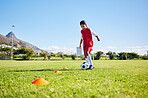 Football girl kid, training and grass for fitness, speed or balance with sport talent development, control and speed. Female child, fast football dribbling or motivation mindset on field in Cape Town