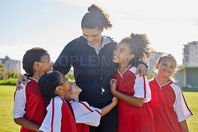 Buy stock photo Girl football team, coach celebration and hug for success, teamwork and group diversity on grass pitch. Young female kids, soccer coaching and love for mentor woman on field for happiness in sunshine