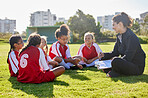 Clipboard, soccer or coach with children planning for strategy, training and team goal in Canada. team building, teamwork and woman coaching group of girl on football field for game, match or workout