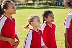 Girl, soccer group and field with smile, team building or solidarity at sport training, strategy or motivation. Female kids, sports planning and diversity with teamwork, friends and focus in football