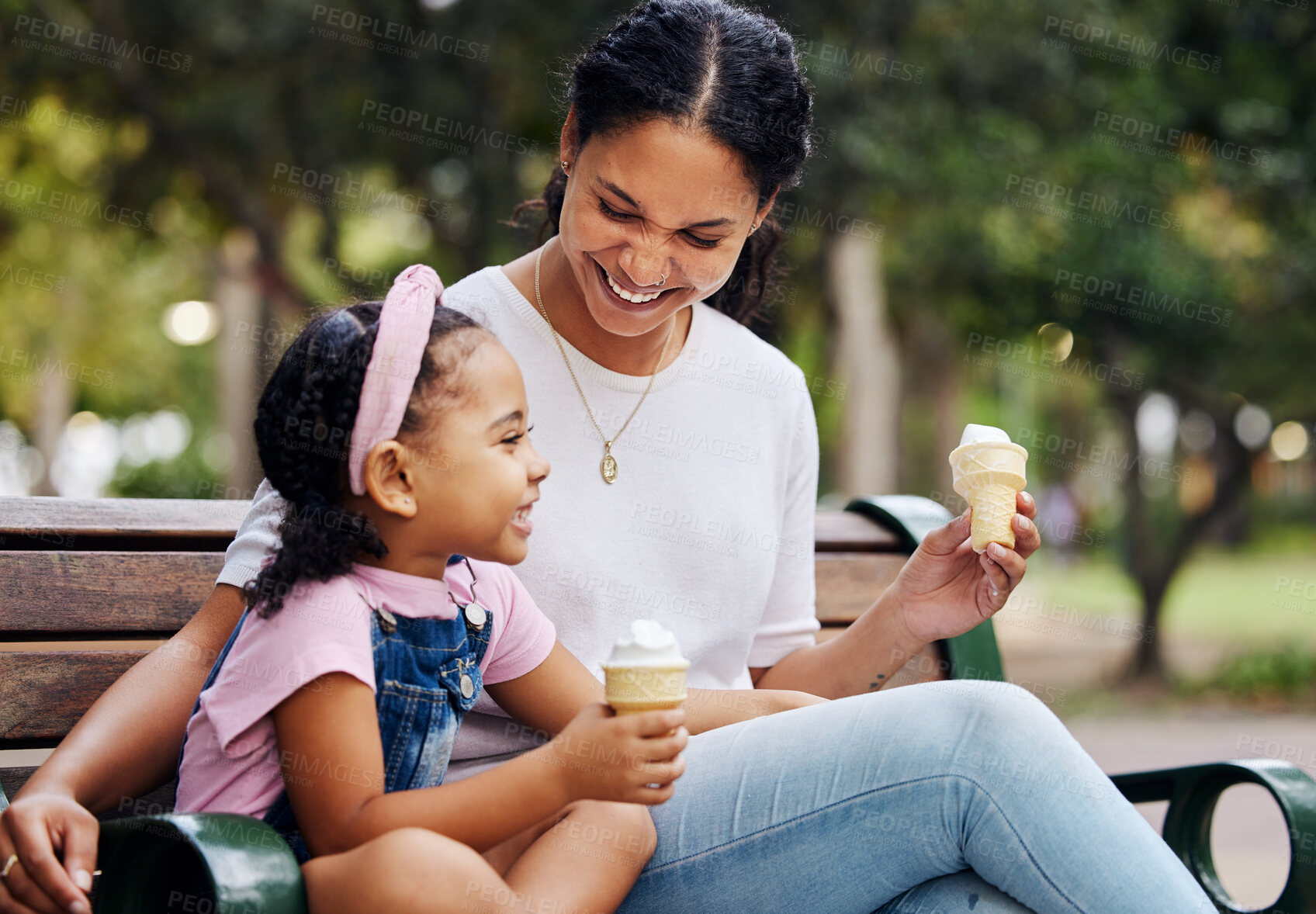 Buy stock photo Summer, park and ice cream with a mother and daughter bonding together while sitting on a bench outdoor in nature. Black family, children and garden with a woman and girl enjoying a sweet snack