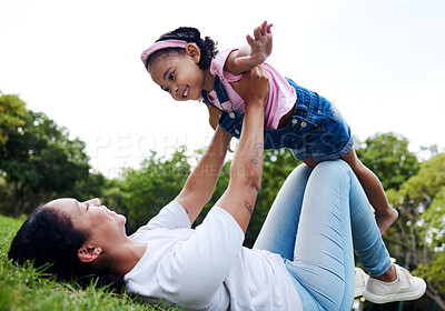 Buy stock photo Black family, park and flying with a mother and daughter having fun together while bonding on grass outdoor. Kids, love and nature with a woman and girl playing in a nature garden outside in summer