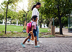 Mother, daughter and walking in a park, relax and bonding while holding hands and talking. Family, black woman and girl with sweet bond of love, enjoying and nature, parenthood and peaceful and day