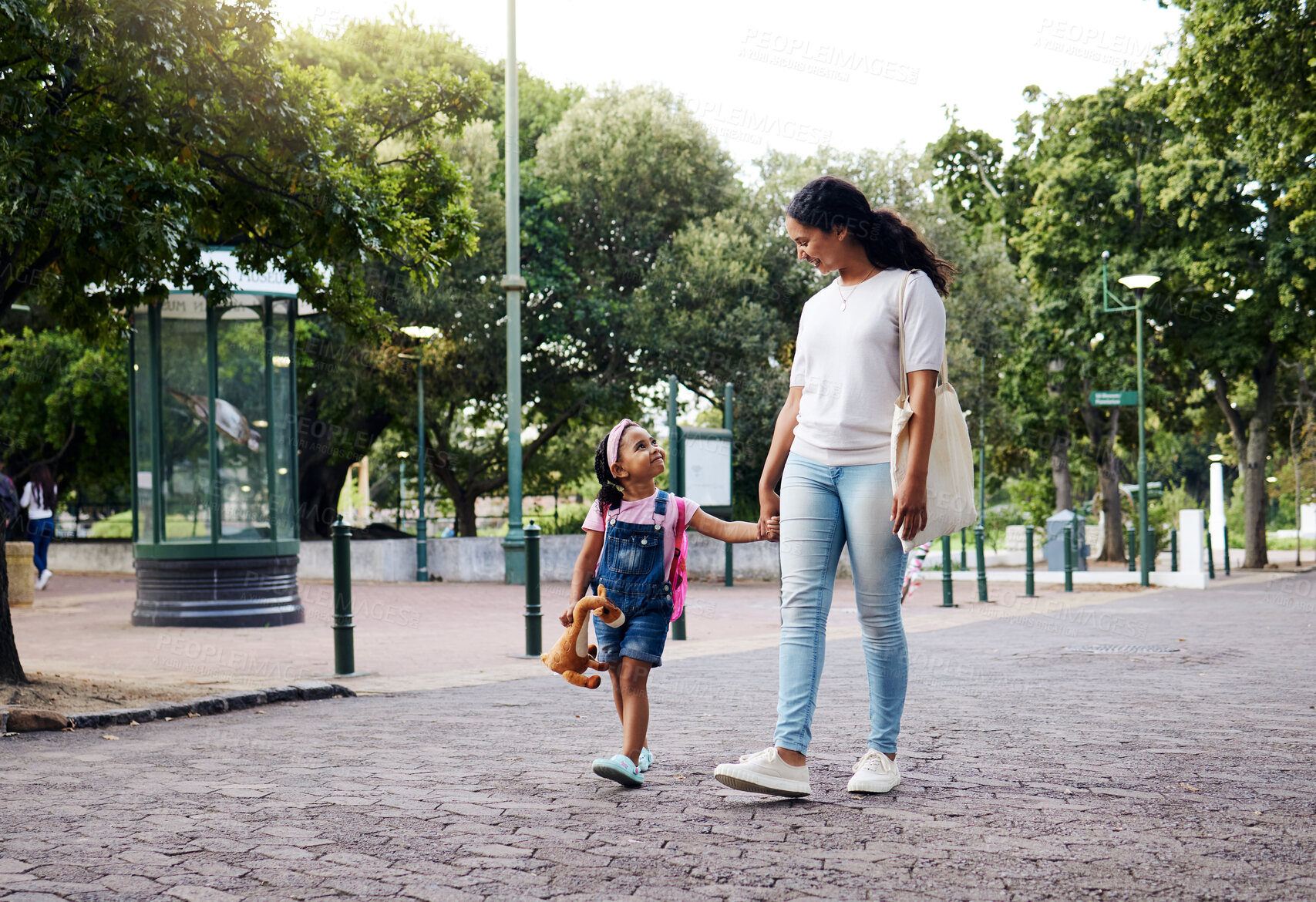 Buy stock photo Park, walking and mom holding hands with girl enjoy weekend, summer holiday and adventure outdoors. Love, black family and mother with child in morning for back to school, kindergarten and education