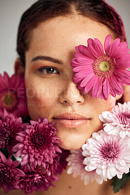 Buy stock photo Flowers, woman and studio portrait for beauty, wellness and skincare with spring aesthetic by background. Model, girl and carnation plants for cosmetic health, healthy face glow or sustainable petals