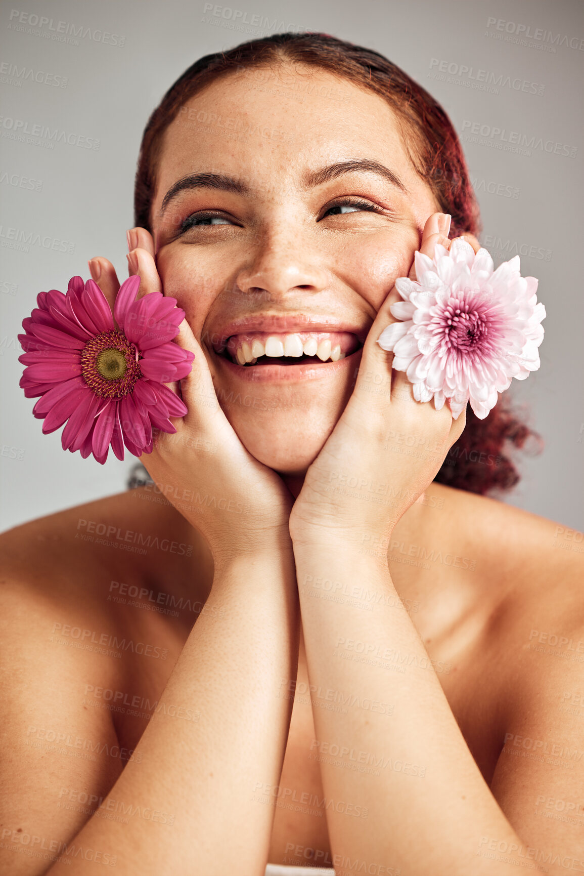 Buy stock photo Woman, flowers and studio headshot with smile for beauty, wellness or skincare with spring aesthetic by backdrop. Model, girl and carnation plant for cosmetic health, skin glow and happy for growth